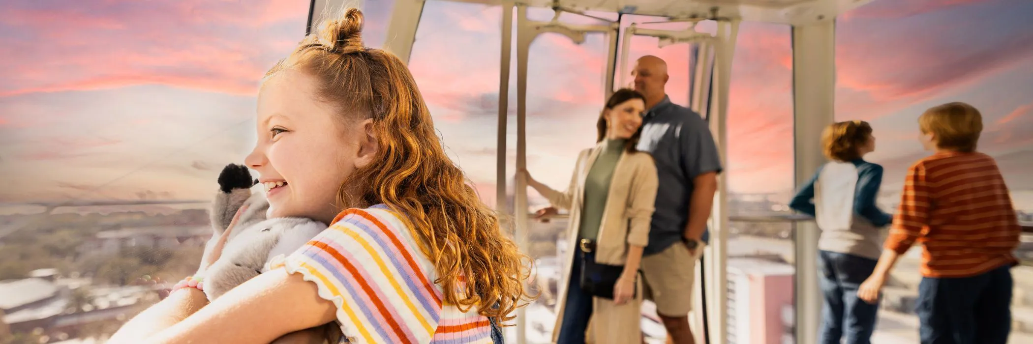 Little girl and her family taking in the sunset in The Orlando Eye capsule.