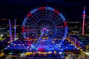 View of the entire Orlando Eye with red and blue lighting.